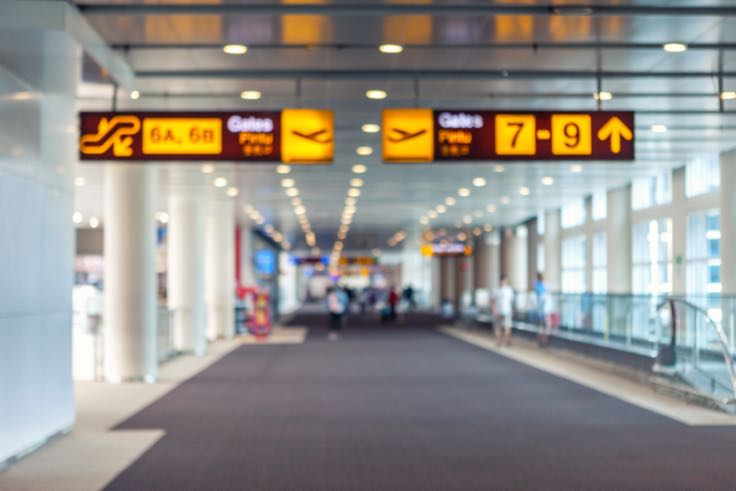 Airport terminal with signs to gates