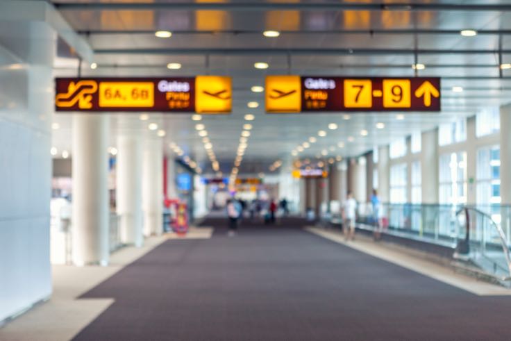 Airport terminal with signs to gates