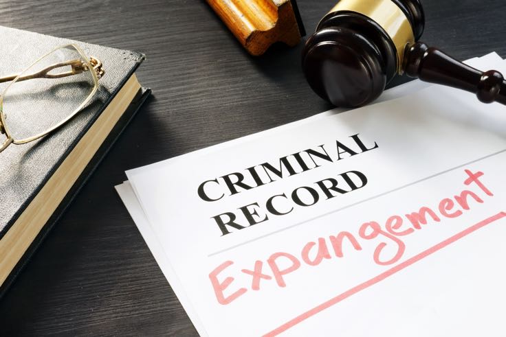 Paperwork for criminal record expungement on desk